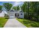 Beautiful new home with lush green lawn, complemented by mature trees and landscaping at 235 Sequoia Dr, Louisburg, NC 27549