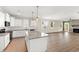 Modern kitchen featuring stainless appliances, granite countertops, and an open layout to the living area at 235 Sequoia Dr, Louisburg, NC 27549