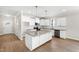 Bright, open kitchen featuring white cabinets, granite countertops, and stainless steel appliances at 235 Sequoia Dr, Louisburg, NC 27549