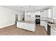 Well-lit kitchen featuring a large island, stainless appliances, and stylish pendant lighting at 235 Sequoia Dr, Louisburg, NC 27549