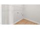 Compact laundry room with laminate flooring, washer hookups, and modern outlets at 235 Sequoia Dr, Louisburg, NC 27549