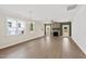 Bright living room featuring hardwood floors, a stone fireplace, and plenty of natural light at 235 Sequoia Dr, Louisburg, NC 27549