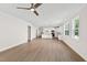 Open-concept living room showcasing hardwood floors and access to modern kitchen with white cabinets at 235 Sequoia Dr, Louisburg, NC 27549