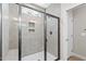 Contemporary bathroom featuring a glass shower enclosure and tiled walls at 235 Sequoia Dr, Louisburg, NC 27549