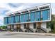 Modern townhome with blue and white siding, solar panels, and stylish staircases leading to each unit at 511 S Bloodworth St # 103, Raleigh, NC 27601