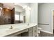 Bathroom with double sink vanity, white countertops, and a tiled shower with glass door at 7533 Poplar Meadow Ln, Raleigh, NC 27616