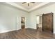 Spacious bedroom with tray ceiling and entrances to the kitchen and bathroom at 7533 Poplar Meadow Ln, Raleigh, NC 27616
