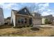 Charming home featuring stone accents, a two-car garage, and well-manicured landscaping at 7533 Poplar Meadow Ln, Raleigh, NC 27616