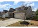 Inviting exterior of a home with stone accents and a two-car garage at 7533 Poplar Meadow Ln, Raleigh, NC 27616