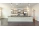 Modern kitchen featuring a large island with granite countertops and stainless steel appliances at 7533 Poplar Meadow Ln, Raleigh, NC 27616