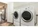 Laundry room featuring large washer and dryer on tile flooring at 7533 Poplar Meadow Ln, Raleigh, NC 27616