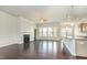 Bright living room featuring a fireplace and open access to the kitchen at 7533 Poplar Meadow Ln, Raleigh, NC 27616
