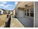 Covered outdoor patio featuring a ceiling fan, gray siding and access to the house at 7533 Poplar Meadow Ln, Raleigh, NC 27616