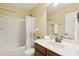 Bathroom with a vanity sink, framed mirror, and a shower-tub combination with a curtain at 8204 Yaxley Hall Dr, Raleigh, NC 27616