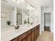 Spacious bathroom featuring double sinks, sleek mirrors, and elegant cabinetry at 8204 Yaxley Hall Dr, Raleigh, NC 27616