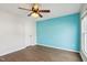 Bedroom featuring a modern ceiling fan and a vibrant blue accent wall at 8204 Yaxley Hall Dr, Raleigh, NC 27616