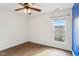 Sunlit bedroom features hardwood floors, a ceiling fan, and a bright window at 8204 Yaxley Hall Dr, Raleigh, NC 27616