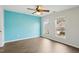 Bedroom features an accent wall, a ceiling fan, and windows that provide natural light at 8204 Yaxley Hall Dr, Raleigh, NC 27616
