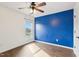 Bedroom with a window, a ceiling fan, an accent wall, and wood-look flooring at 8204 Yaxley Hall Dr, Raleigh, NC 27616