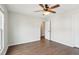 Bright bedroom featuring wood flooring and a ceiling fan, flooded with natural light at 8204 Yaxley Hall Dr, Raleigh, NC 27616
