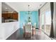 Dining area with modern chandelier, sliding glass door, and view into kitchen at 8204 Yaxley Hall Dr, Raleigh, NC 27616