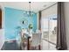 Bright dining room features sleek hardwood floors, modern chandelier, and a sliding glass door to the patio at 8204 Yaxley Hall Dr, Raleigh, NC 27616