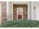 Inviting front door with stone accents and lush landscaping at 8204 Yaxley Hall Dr, Raleigh, NC 27616