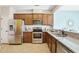Spacious kitchen featuring stainless steel appliances, granite countertops, and ample cabinet space at 8204 Yaxley Hall Dr, Raleigh, NC 27616