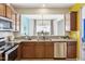 A view from the kitchen of the dining area's stylish chandelier and sliding glass doors at 8204 Yaxley Hall Dr, Raleigh, NC 27616