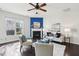 Sunlit living room with fireplace, stylish decor, and large window overlooking the outdoors at 8204 Yaxley Hall Dr, Raleigh, NC 27616