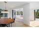 Bright dining room with wooden table and access to a sunroom and deck at 1232 Somerset Rd, Raleigh, NC 27610