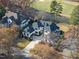 This aerial view showcases the luxury home, mature trees, and golf course in the neighborhood at 1309 Briar Patch Ln, Raleigh, NC 27615