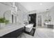 Bright bathroom with freestanding tub, glass shower, dual vanities, and modern lighting fixtures at 1309 Briar Patch Ln, Raleigh, NC 27615