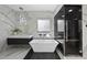 Luxury bathroom featuring freestanding tub, glass shower, dual sinks, and marble accents at 1309 Briar Patch Ln, Raleigh, NC 27615