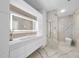 Modern bathroom featuring marble tile, sleek vanity, and walk-in shower at 1309 Briar Patch Ln, Raleigh, NC 27615