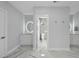 Bright, neutral bathroom with double vanities, marble floors and counters, and a separate water closet at 1309 Briar Patch Ln, Raleigh, NC 27615