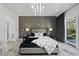 Spacious bedroom with modern lighting, textured accent wall, and access to outside at 1309 Briar Patch Ln, Raleigh, NC 27615