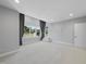 Bonus room featuring neutral carpet, paint, and a door leading to the backyard at 1309 Briar Patch Ln, Raleigh, NC 27615