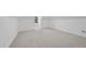 Attic bonus room with neutral carpet, white walls, recessed lights, and a small window at 1309 Briar Patch Ln, Raleigh, NC 27615