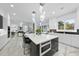 Bright, modern kitchen with large island, marble floors, and views of the manicured backyard at 1309 Briar Patch Ln, Raleigh, NC 27615