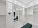 Organized walk-in closet featuring mirrored doors, built-in shelving, and benches for seating at 1309 Briar Patch Ln, Raleigh, NC 27615
