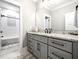 Modern bathroom with granite countertop and gray cabinets at 145 Wiggins Rd, Louisburg, NC 27549