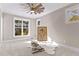 Bright bedroom with large windows, plush carpet, and ceiling fan at 145 Wiggins Rd, Louisburg, NC 27549