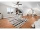 Large bonus room with hardwood floors, seating area, and kitchenette at 145 Wiggins Rd, Louisburg, NC 27549