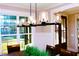 Bright dining room features a rustic wood table with leather chairs and a modern chandelier at 145 Wiggins Rd, Louisburg, NC 27549