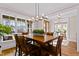 Spacious dining area with a large wooden table, modern chandelier, and hardwood floors at 145 Wiggins Rd, Louisburg, NC 27549