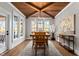 Bright dining room with hardwood floors, large windows, and a tray ceiling at 145 Wiggins Rd, Louisburg, NC 27549