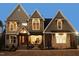 Two-story home with stone accents and a large front porch at 145 Wiggins Rd, Louisburg, NC 27549