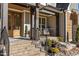 Inviting front porch with brick steps and metal railing at 145 Wiggins Rd, Louisburg, NC 27549