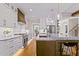 Modern kitchen features white cabinets, granite countertops, and a large island with seating at 145 Wiggins Rd, Louisburg, NC 27549